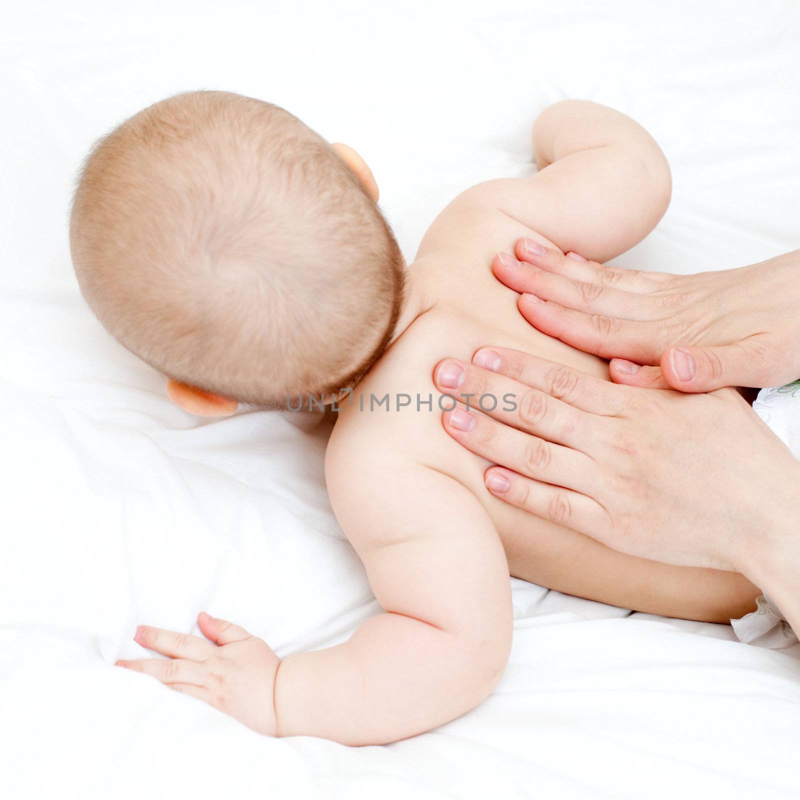 Mother massaging her child, shallow focus