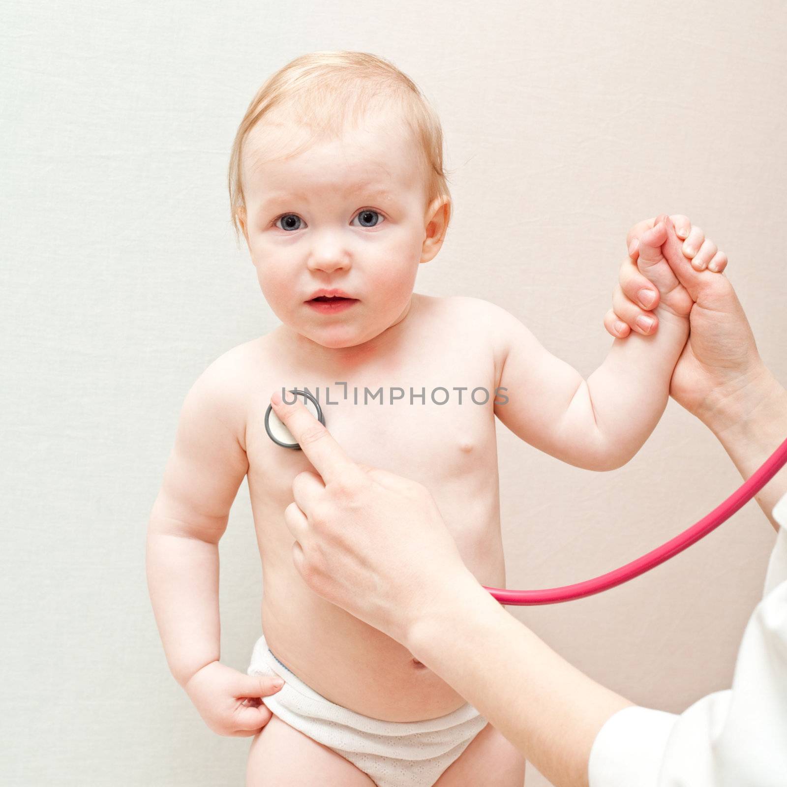 Children's doctor exams infant with stethoscope