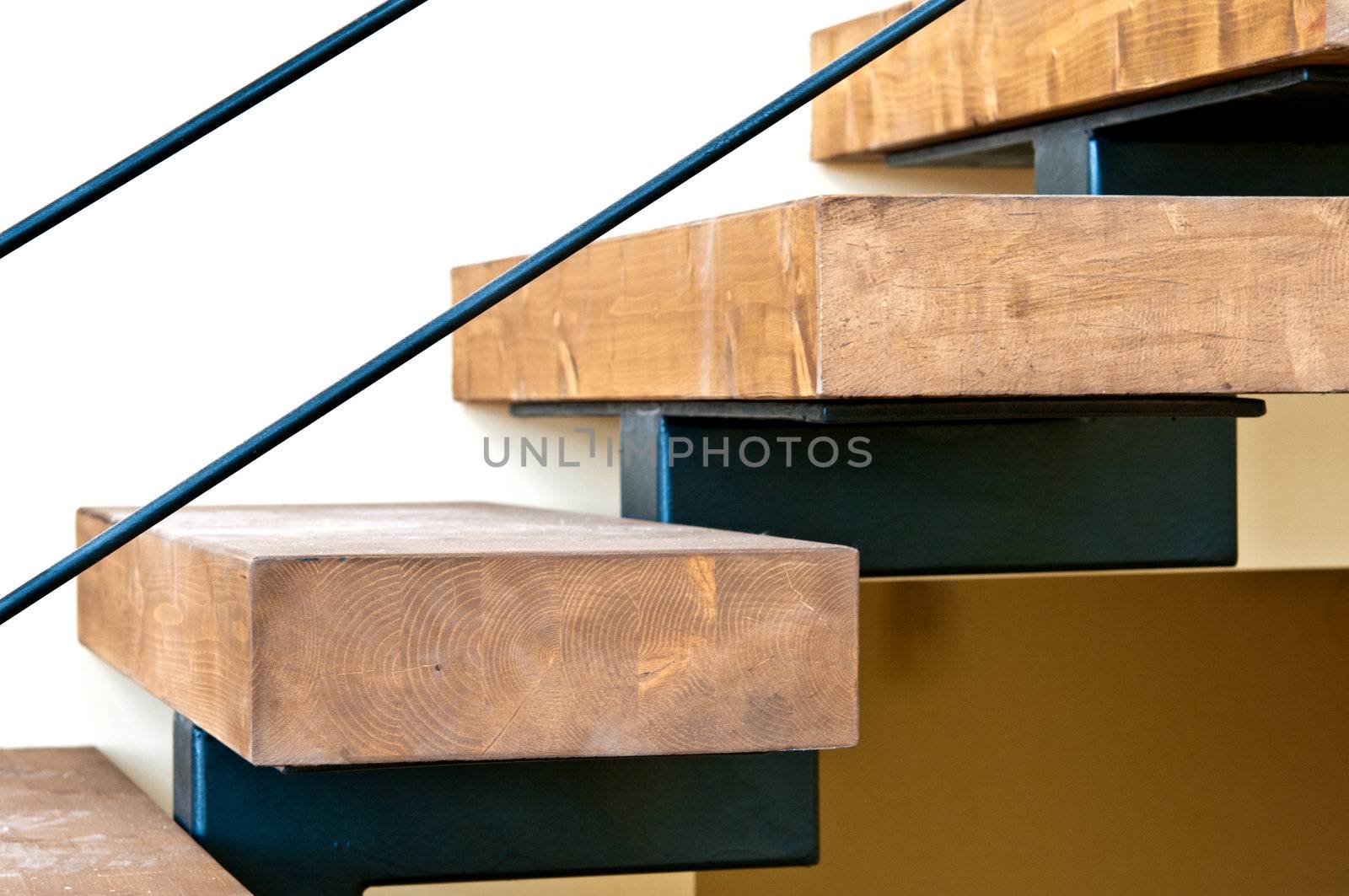 Wooden stairs and solid laminated wood mounted on a metal base