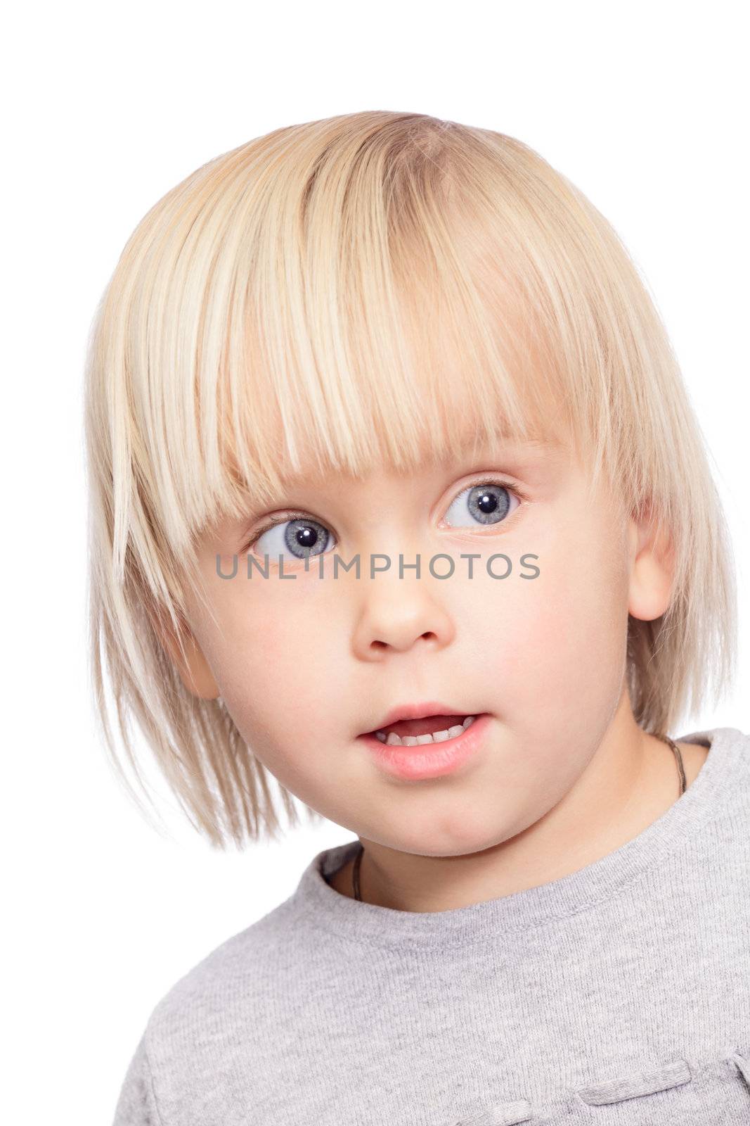 Portrait of attentive cute little girl looking side on white background