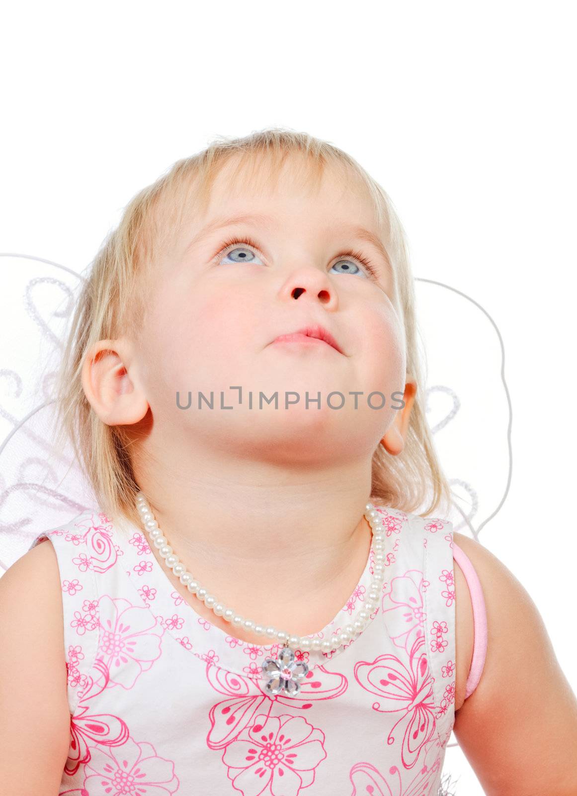 Portrait of cute little girl wearing wings looking up
