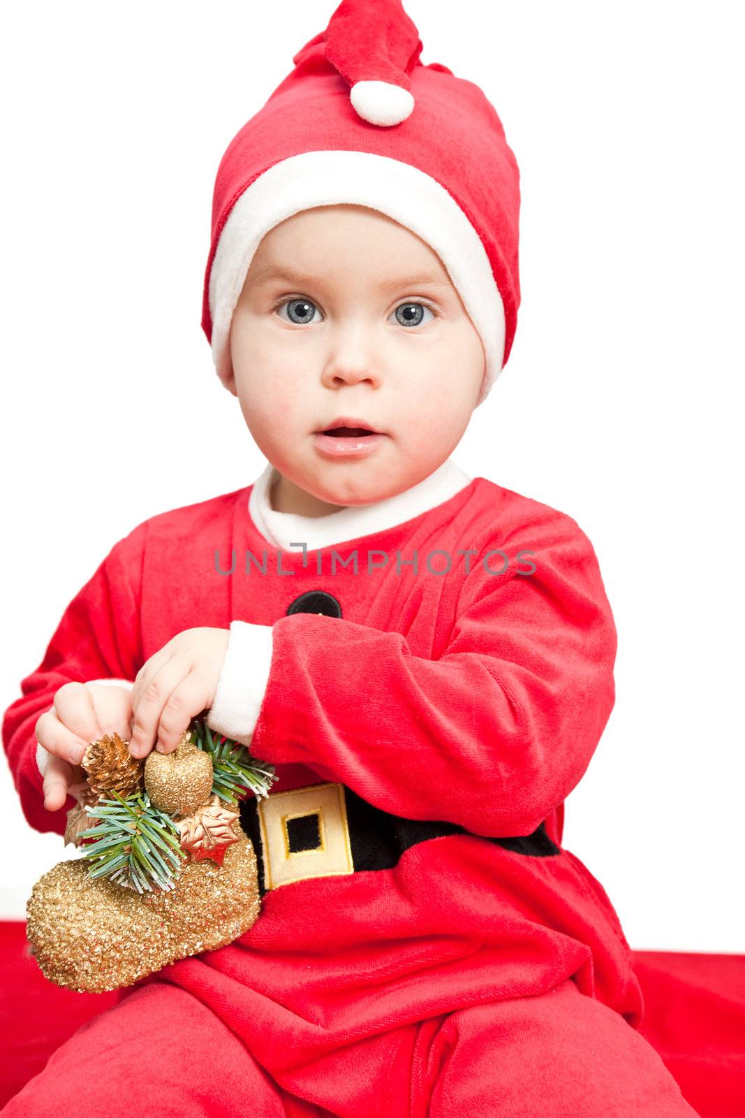 Little baby girl with christmas boot wearing Santa Claus costume on white background