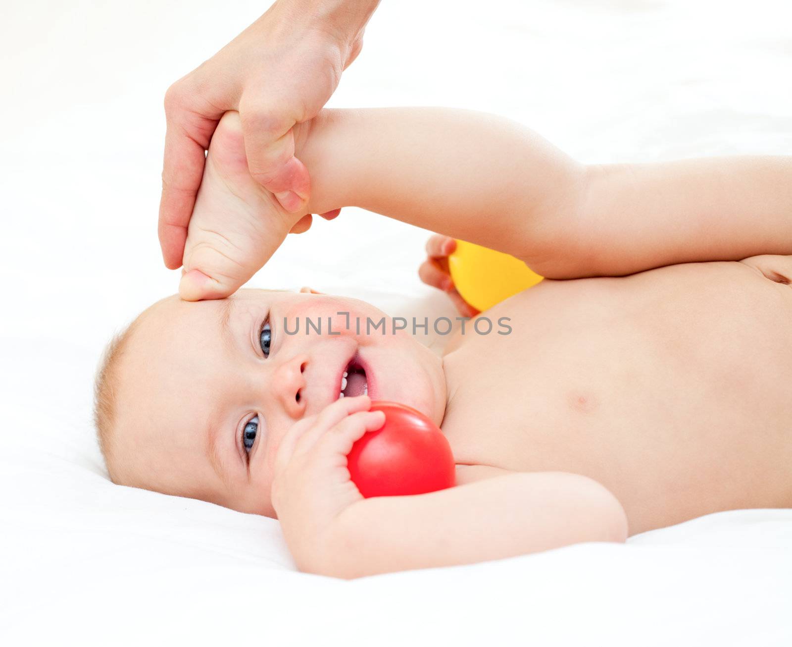 Cute little baby girl taking exercise