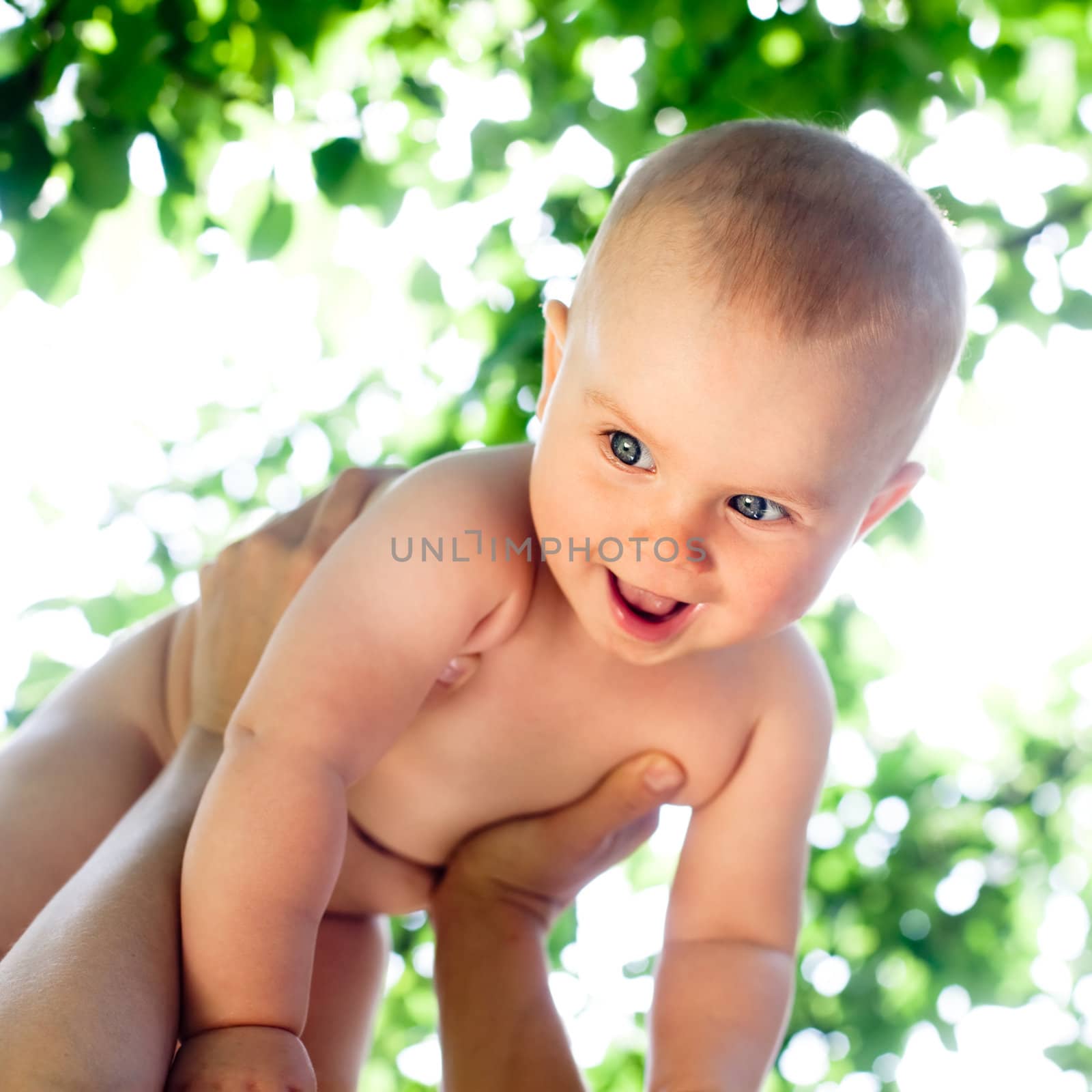 Infant in a summer garden by naumoid