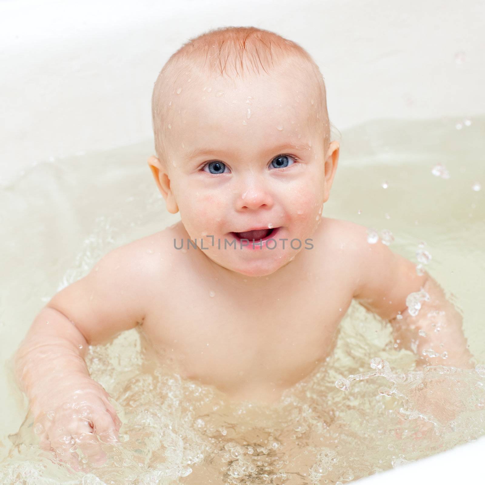 Cute little baby girl bathing