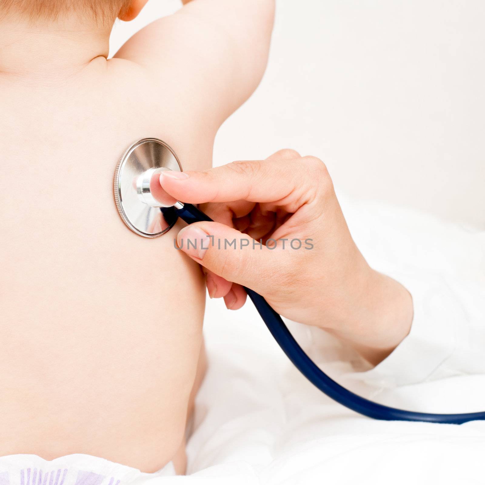 Children's doctor exams infant with stethoscope