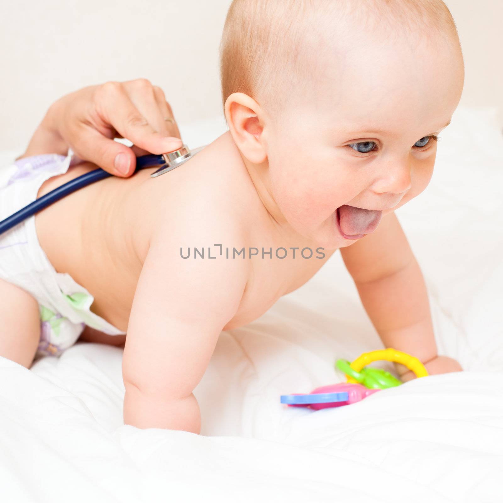 Pediatric doctor exams little baby girl with stethoscope