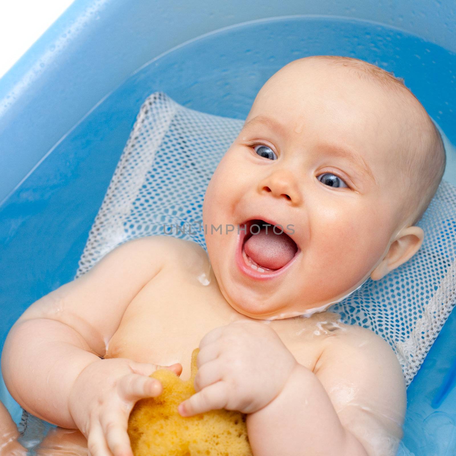 Happy bathing little baby girl