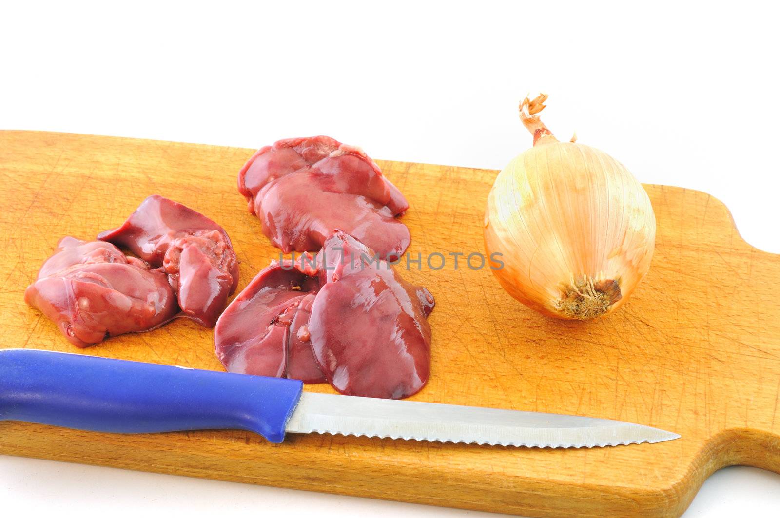 Fresh raw chicken liver lies on a wooden board next to the knife and onion