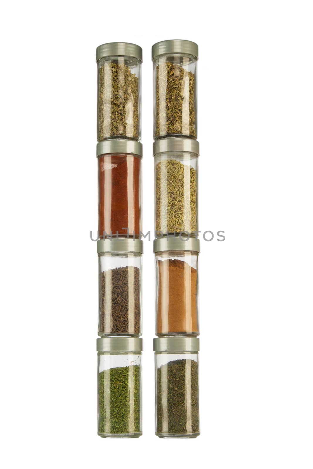 Bottles of colorful spices on white background