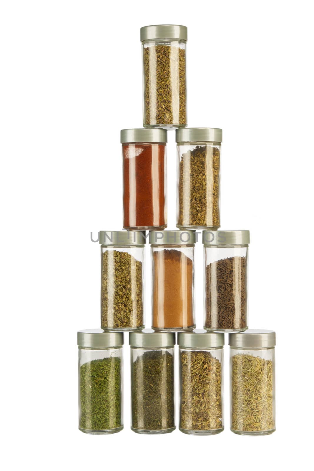 Bottles of colorful spices on white background