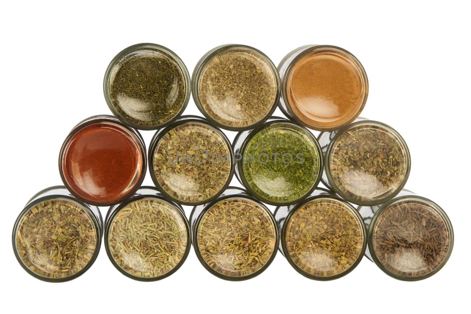 Bottles of colorful spices on white background