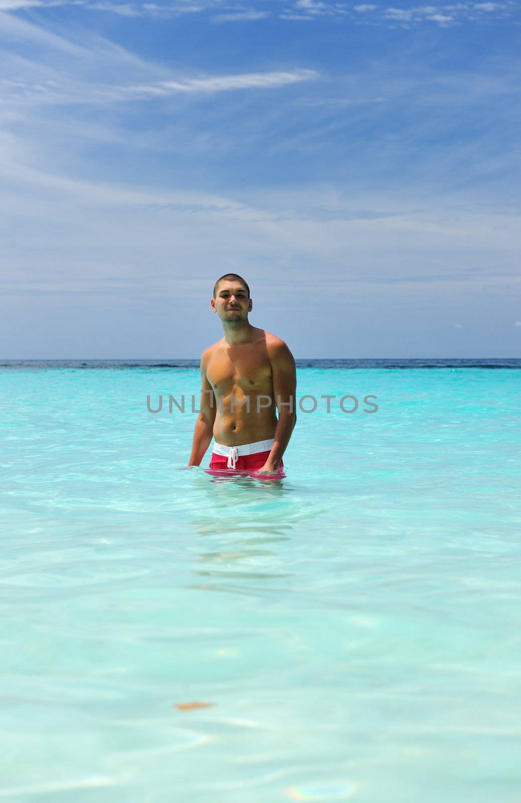 Man in water at tropical beach