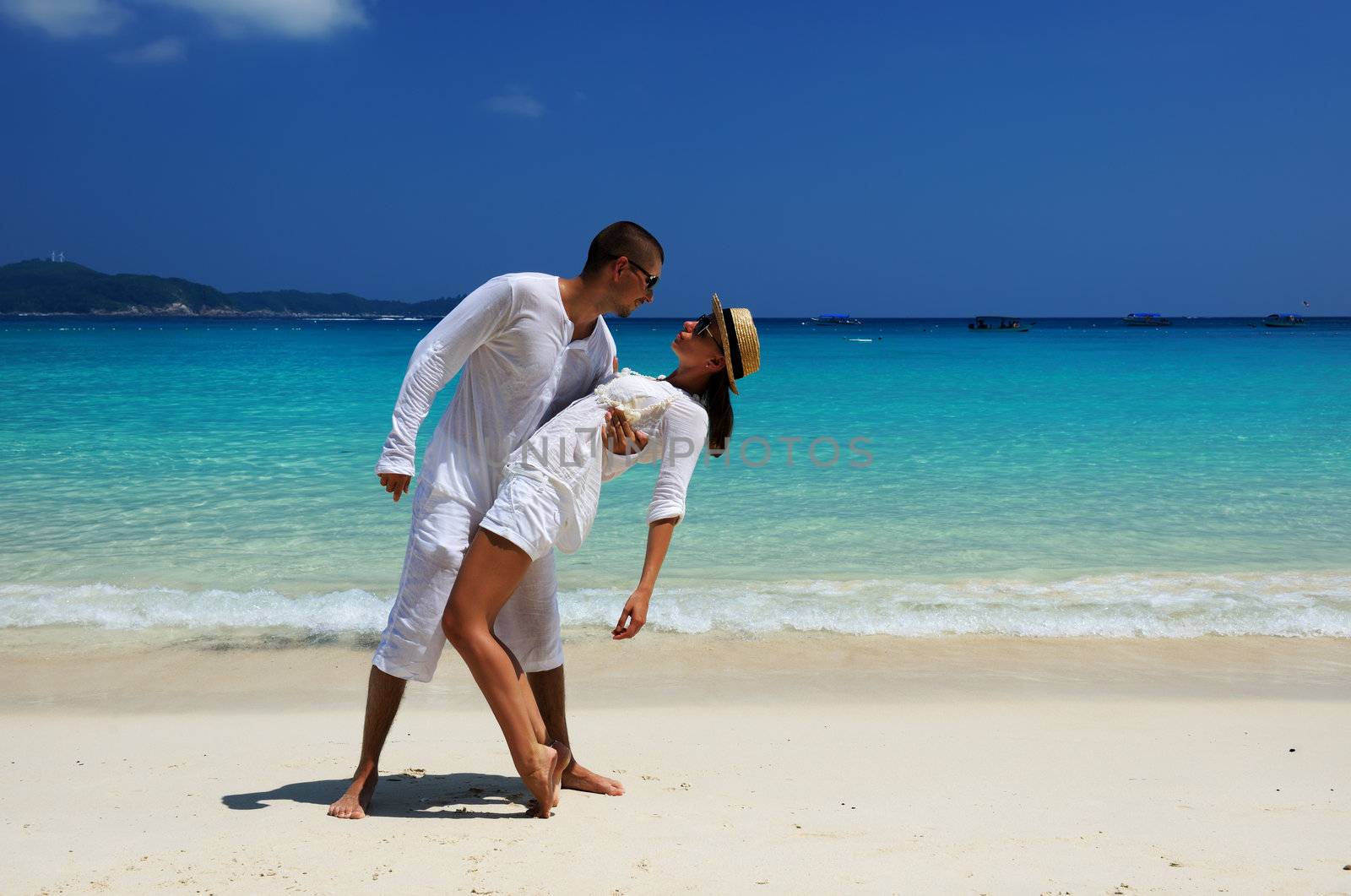 Couple in white on a tropical beach