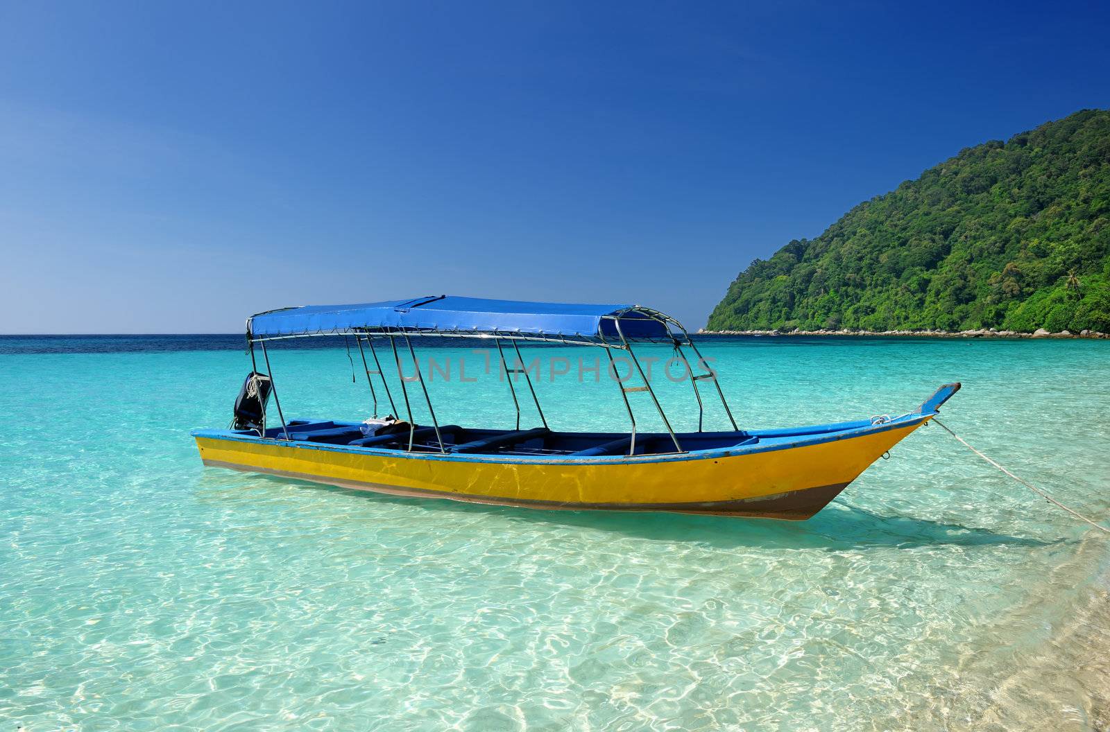 Beautiful beach with motor boat at Perhentian islands, Malaysia