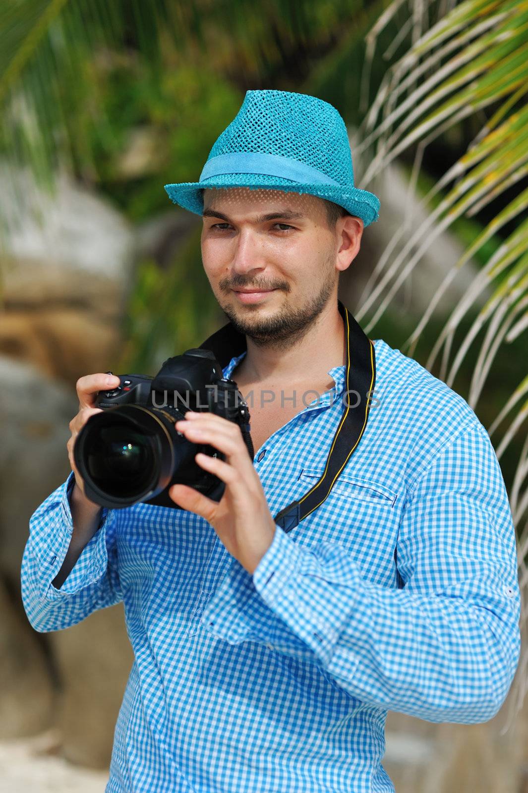 Man on a beach with camera