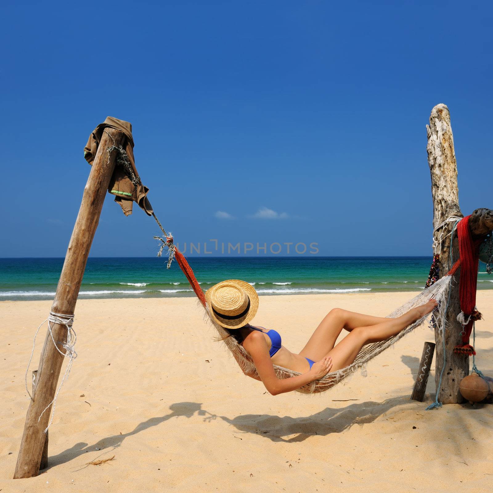 Woman in hammock on tropical beach at Tioman island, Malaysia