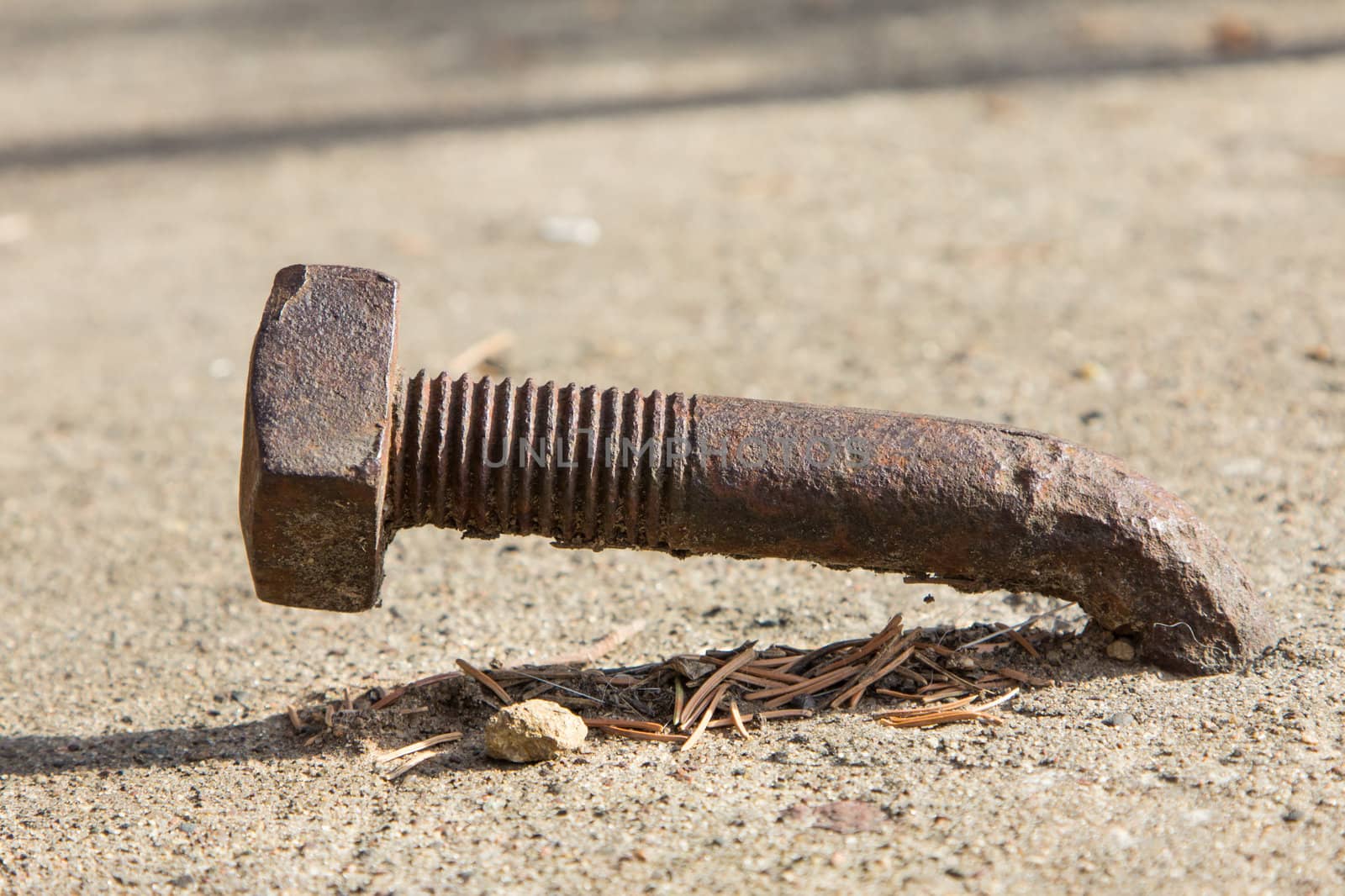 Rusty Bent Lag Bolt in Concrete by wolterk