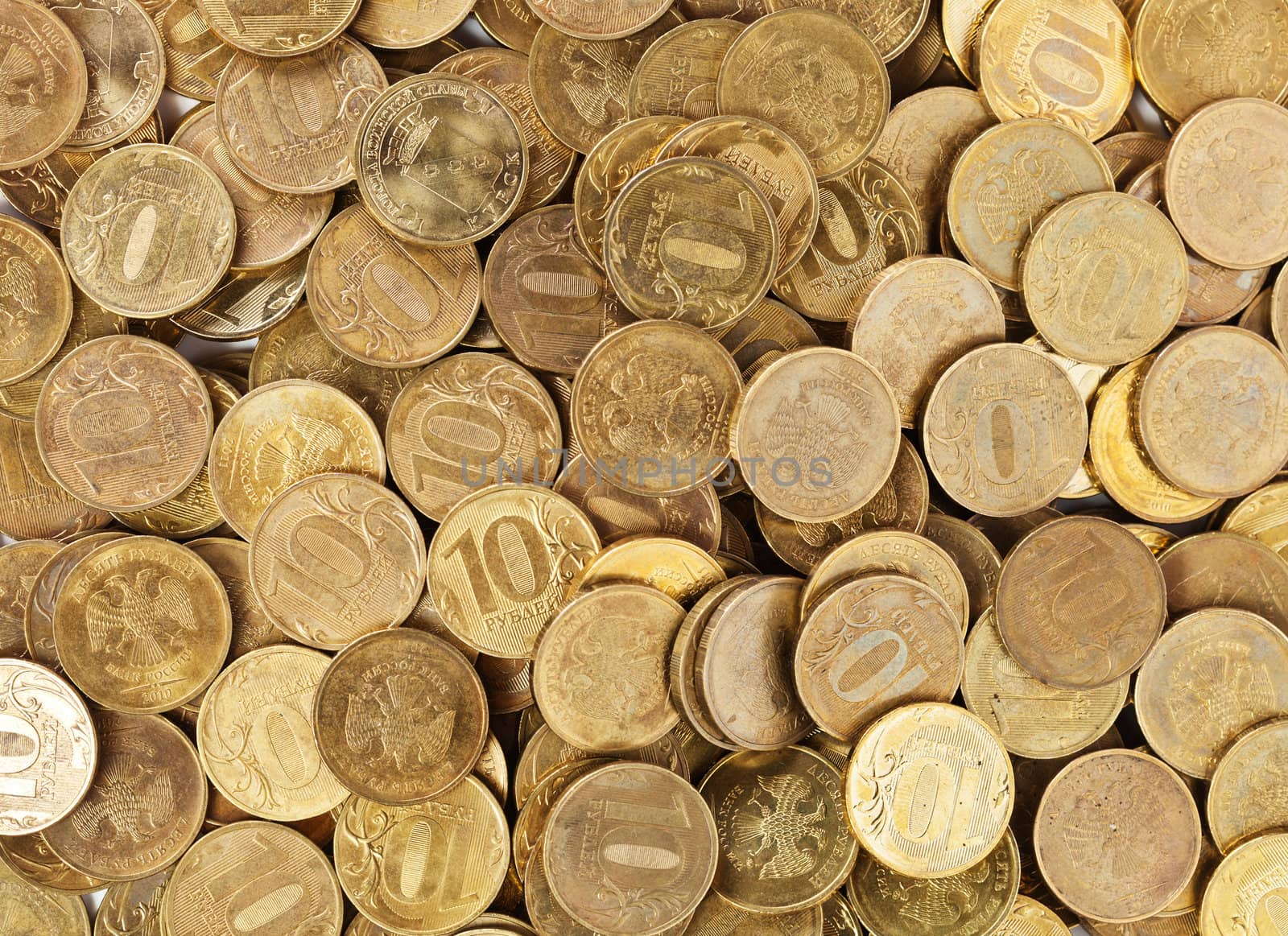 Heap of golden coins close up background