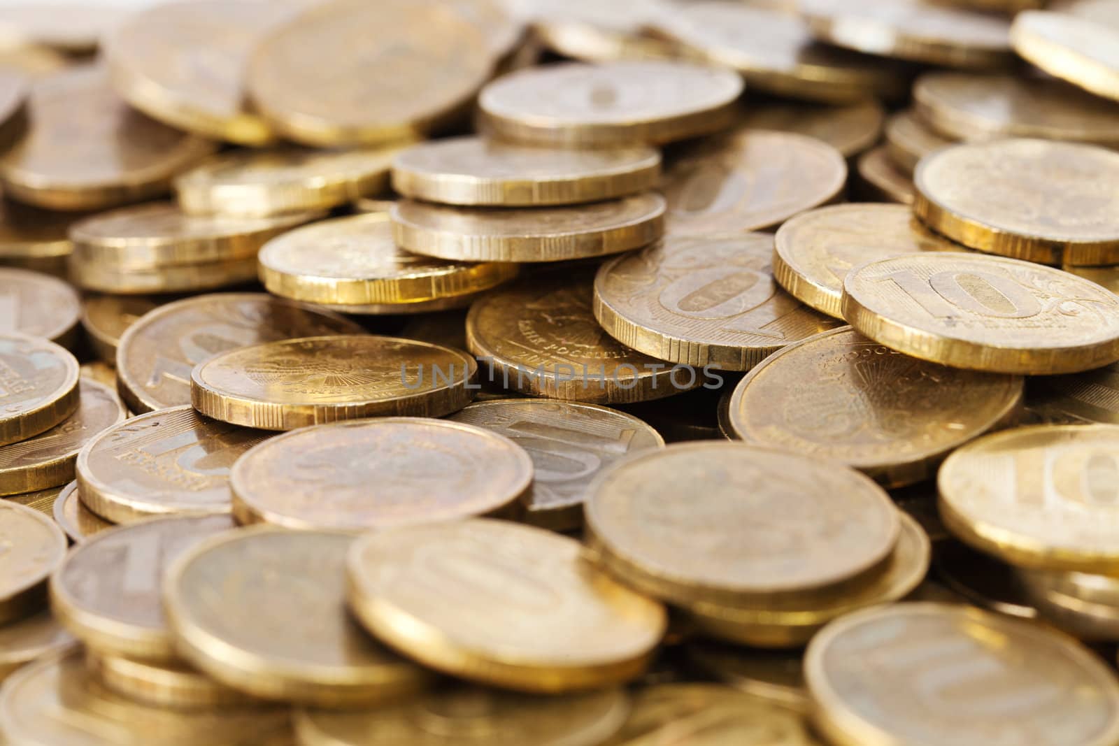 Heap of golden coins close up background