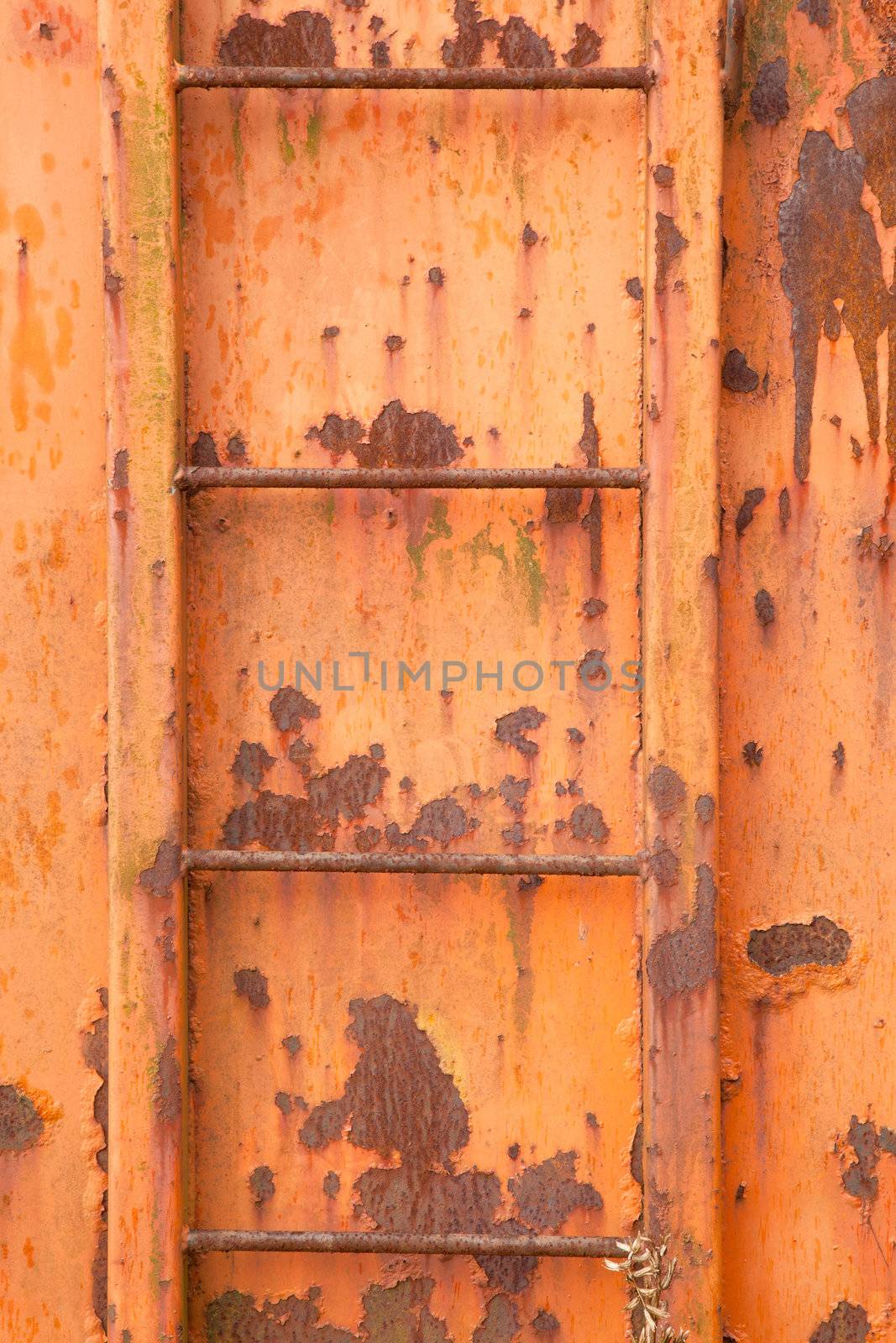 steps of old orange and rusty container on vertical image by ahavelaar