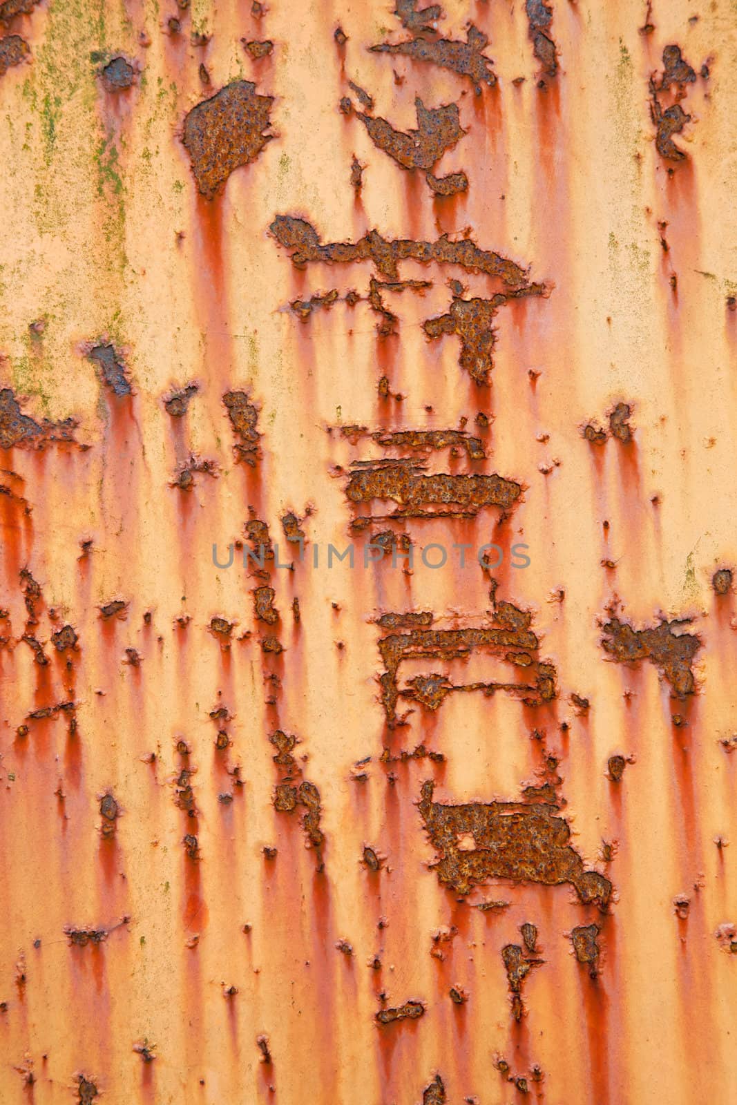 vertical part of old weathered metal with orange paint by ahavelaar