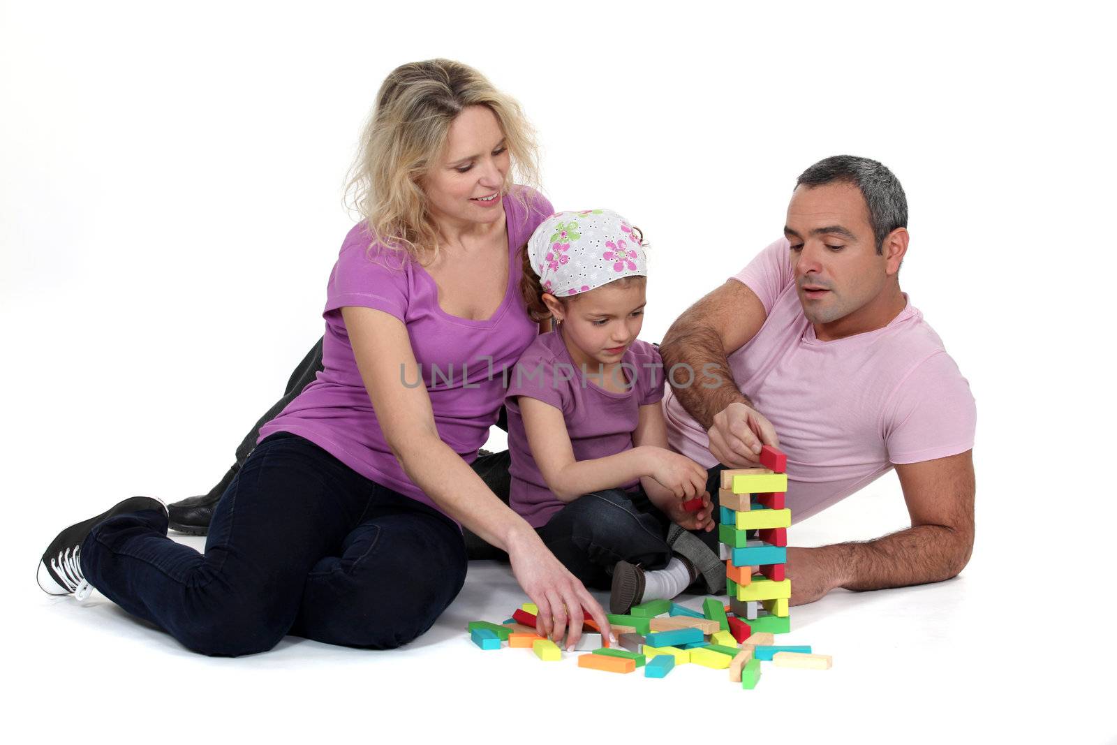 Family playing with building blocks by phovoir