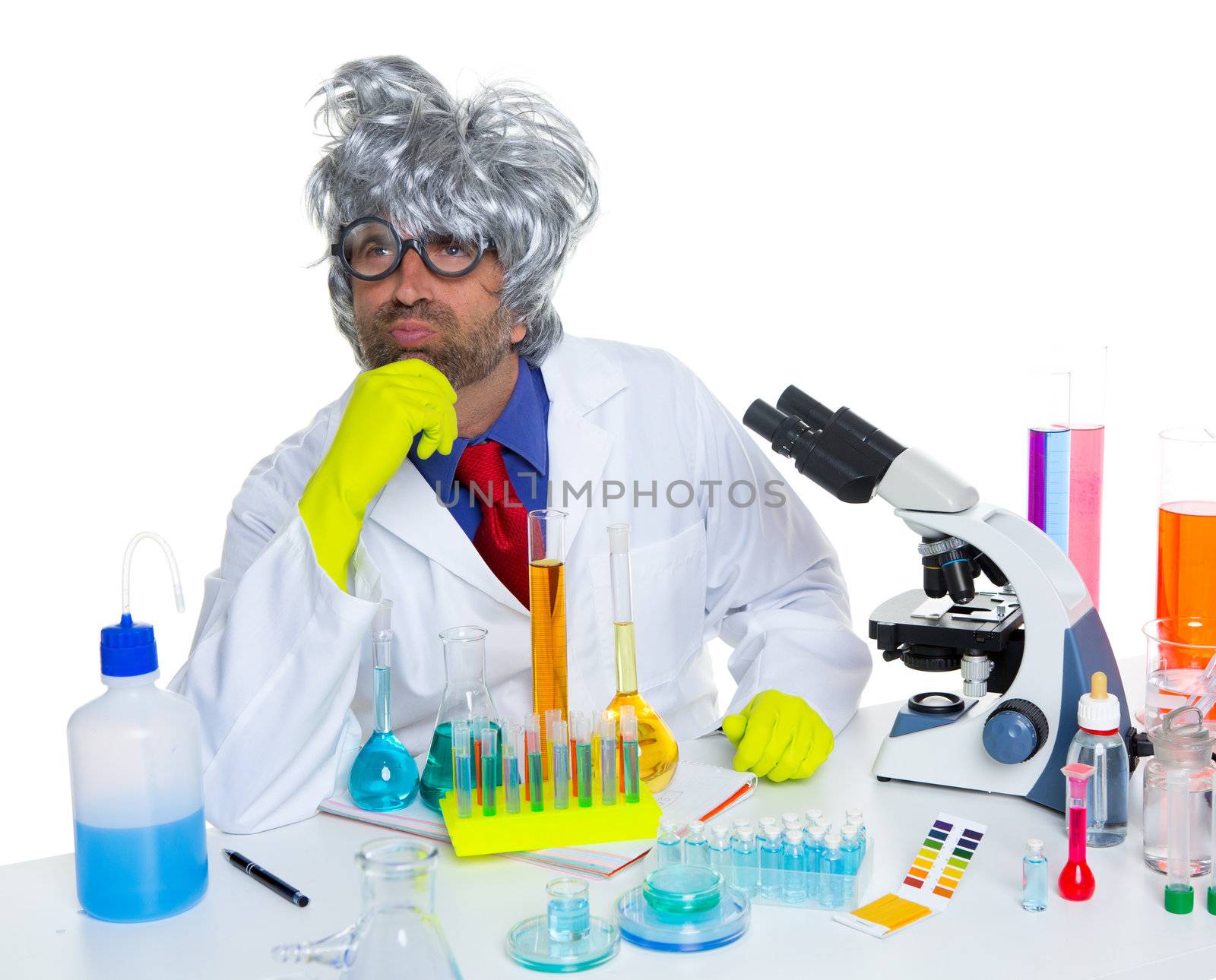 Carzy pensive nerd scientist at chemical laboratory thinking with microscope