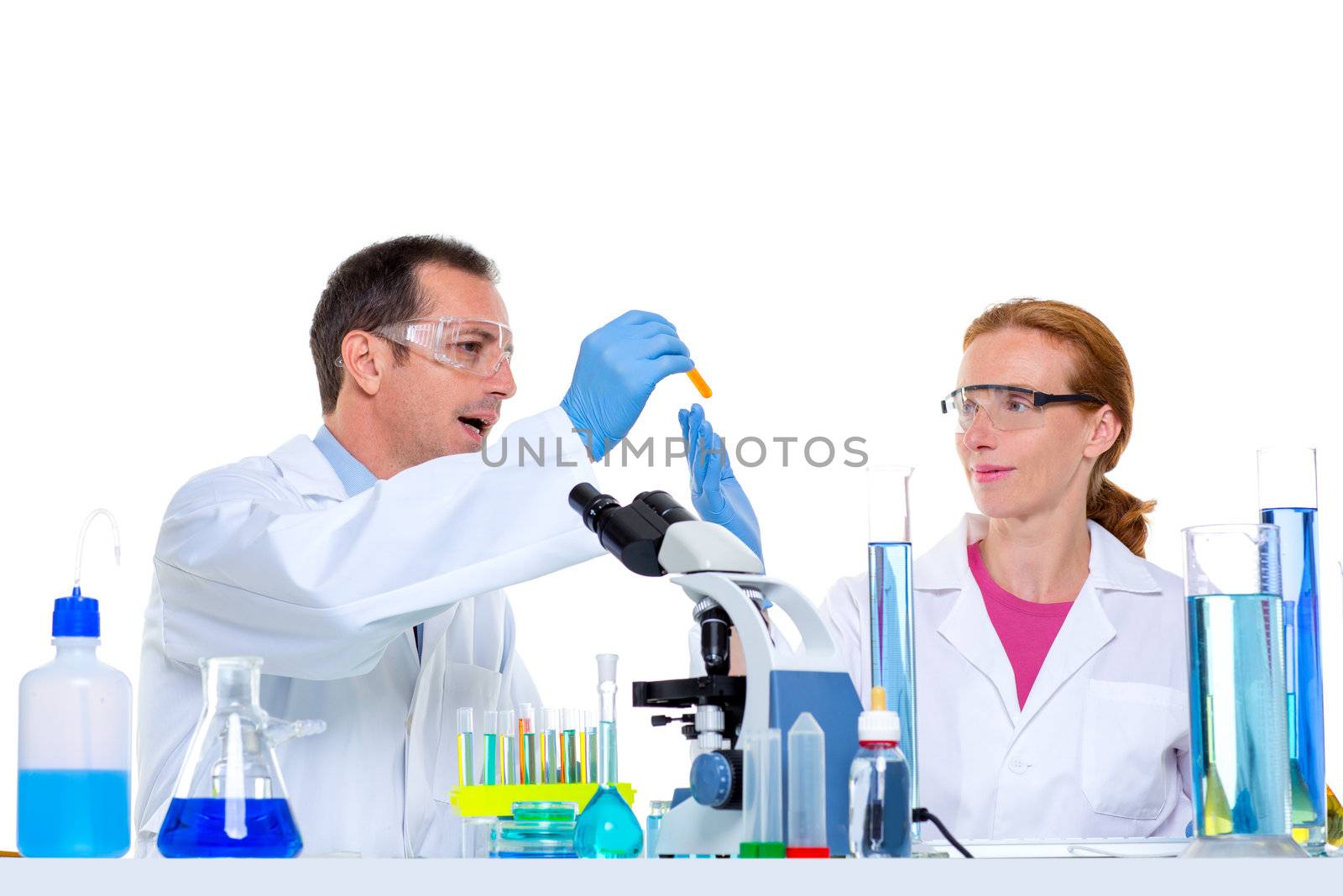 laboratory with two scientist working with test tubes flask and microscope
