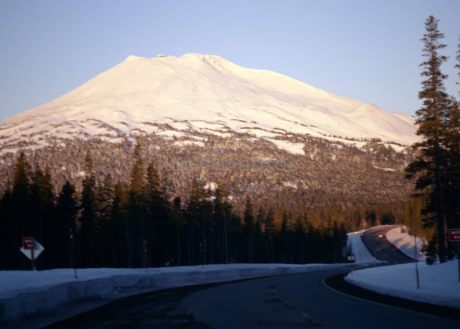 Highway passing near majestic snow capped mountain in Cascades range in Oregon