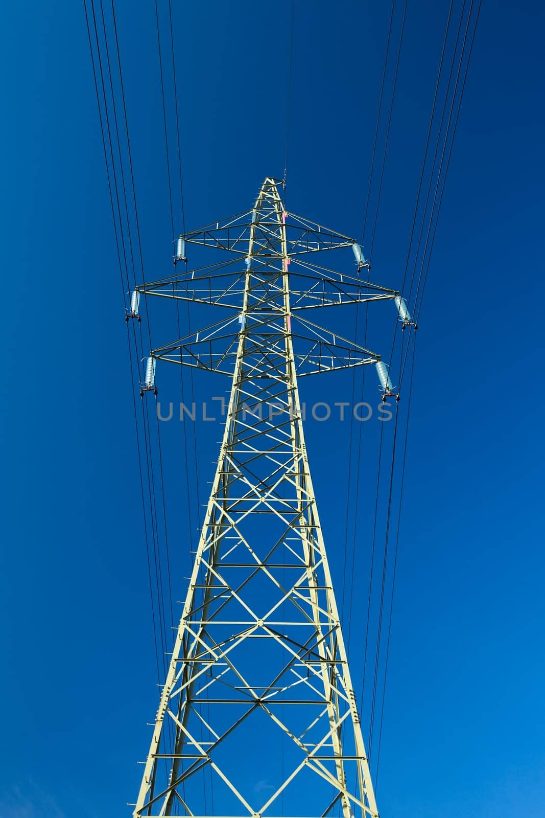 High voltage electric line against blue sky
