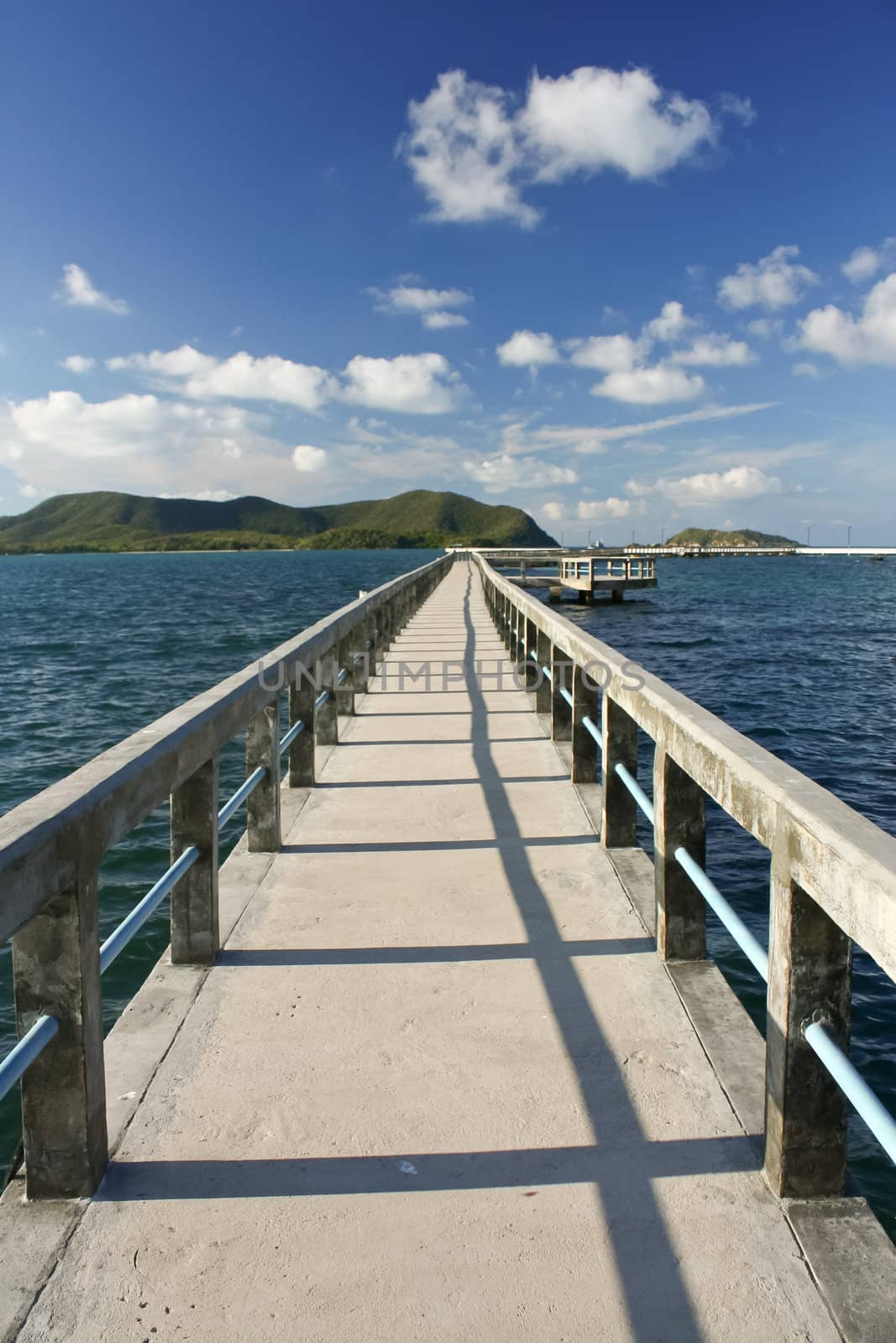 concrete jetty with railing over sea by tore2527