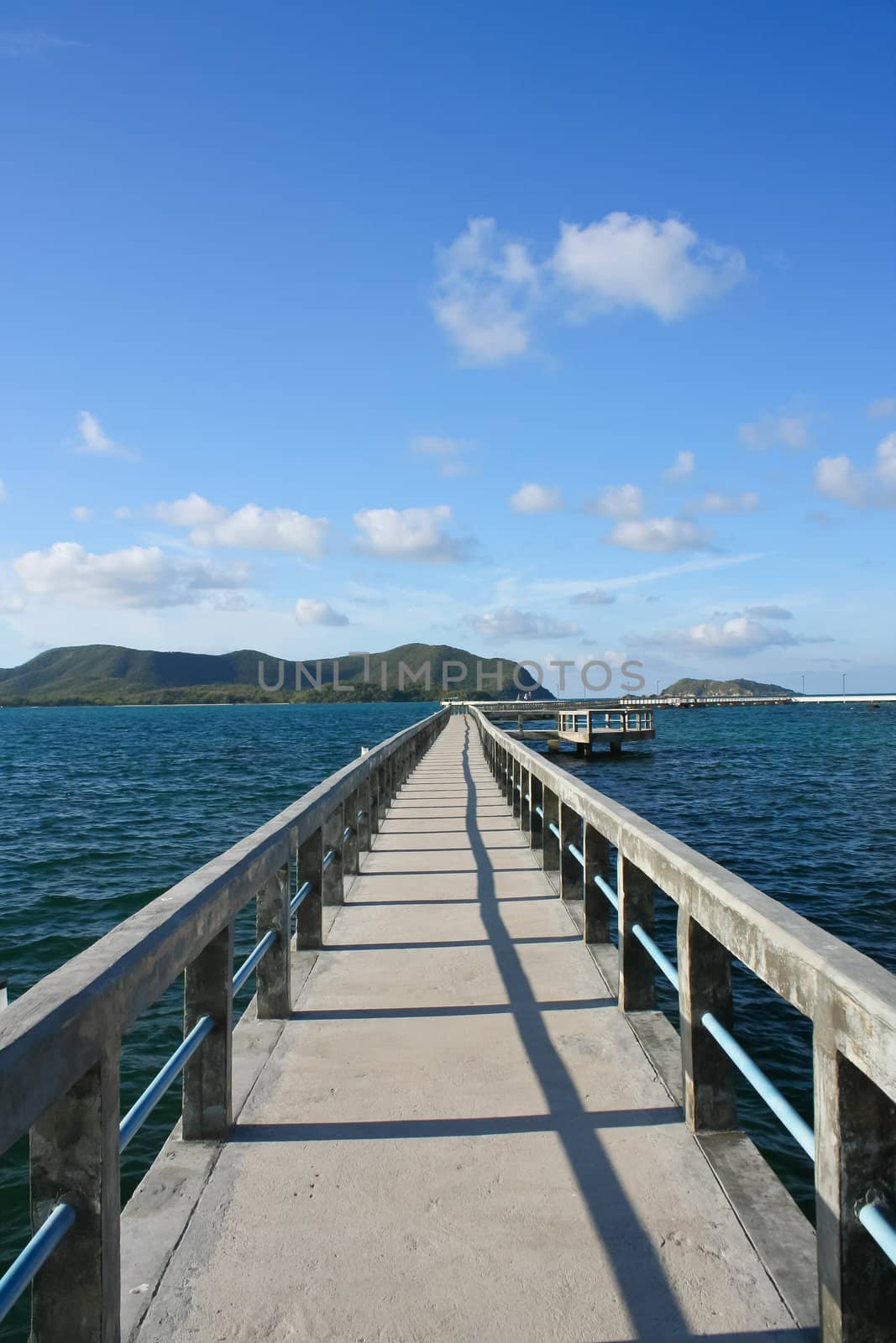 concrete jetty with railing over sea at Sattaheep beach, Thailand