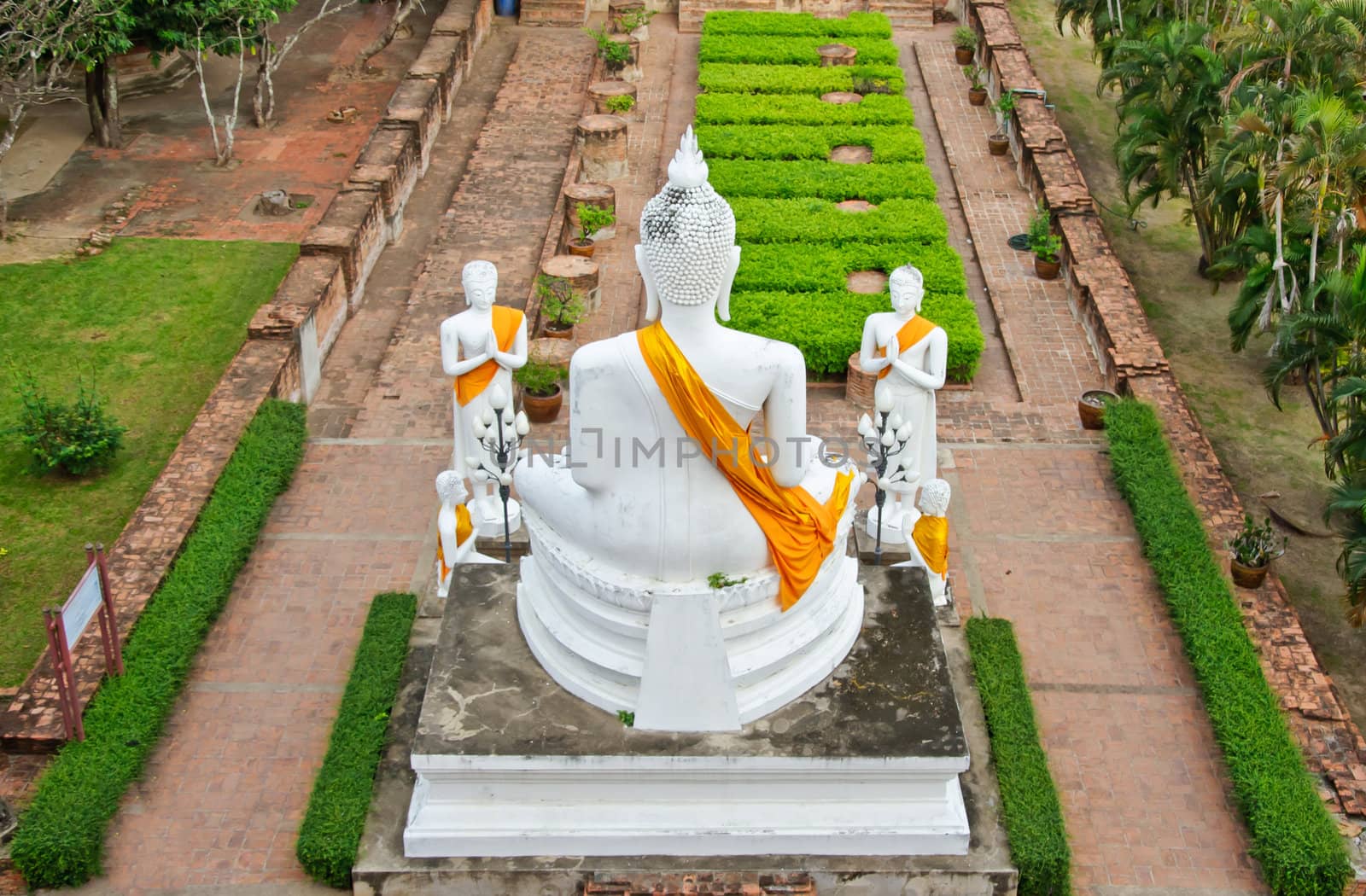 The white buddha statue in ruined old temple at Wat Yai Chai Mongkol temple, Ayutthaya, Thailand