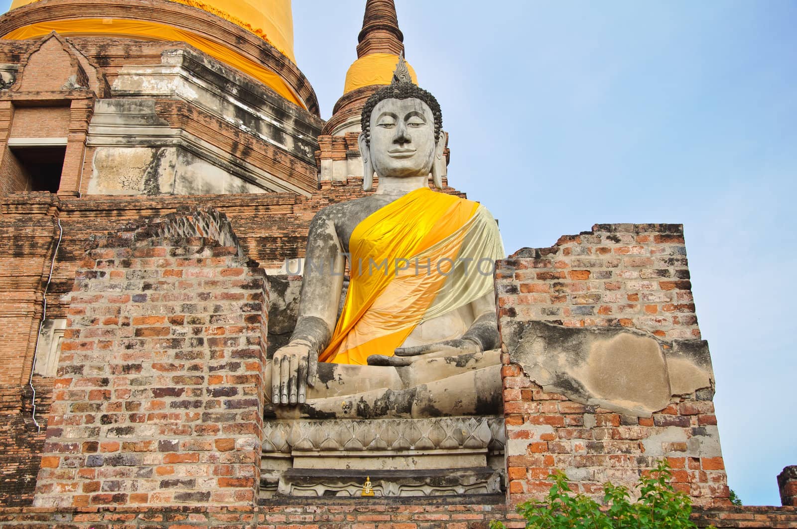 The big ancient buddha statue in ruined old temple at Wat Yai Chai Mongkol temple, Ayutthaya, Thailand