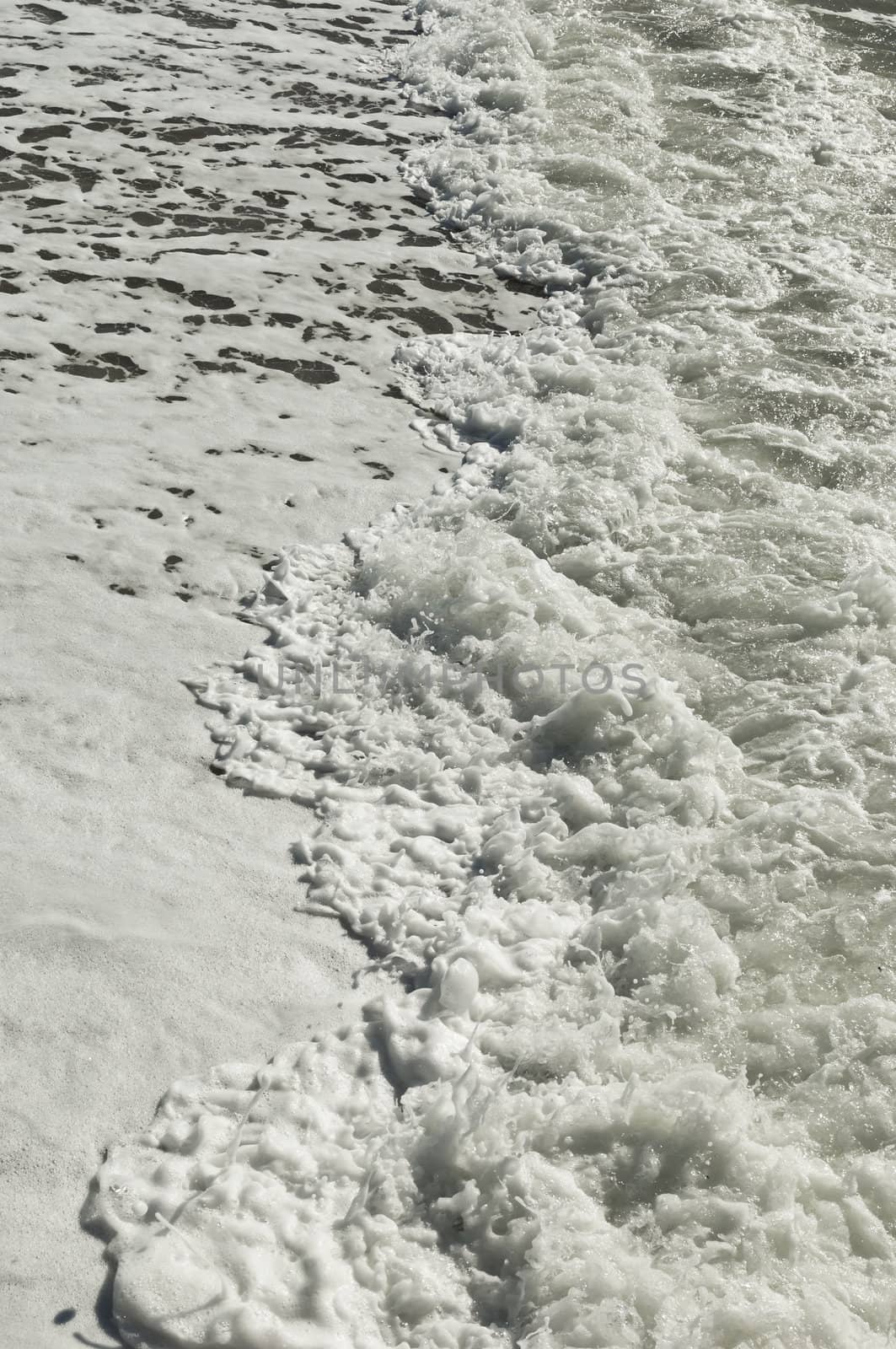 Closeup of beautiful white sea foam and waves