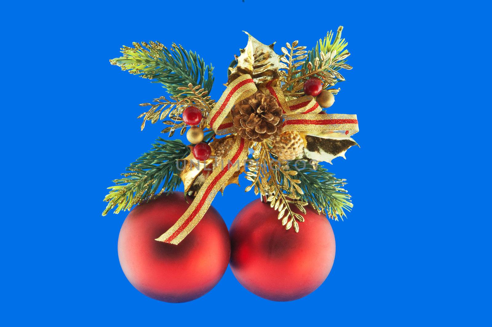 red balls, cone spruce, fir and sprigs to decorate for Christmas against a blue background