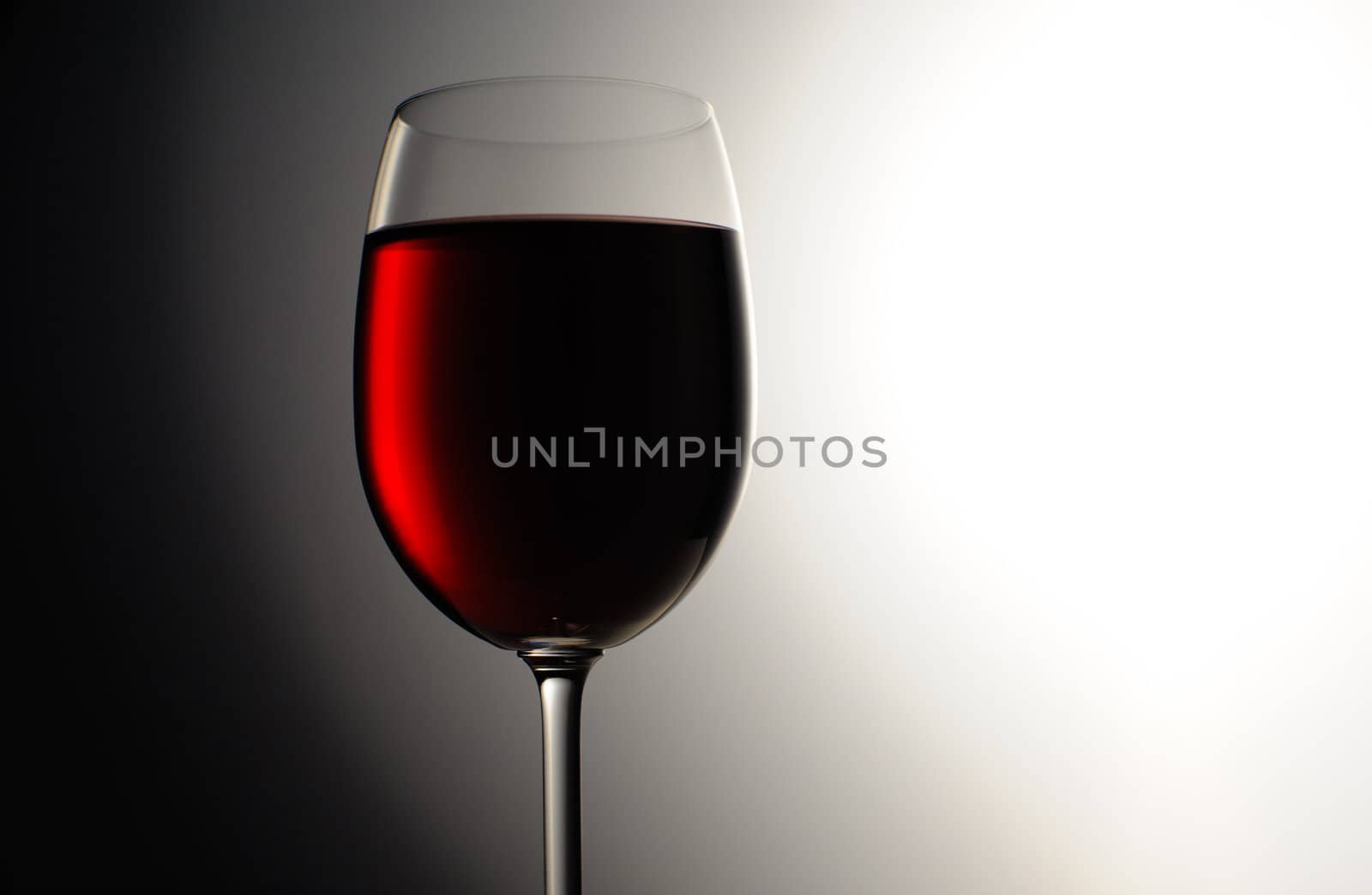 Closeup of red wine wineglass on dark background