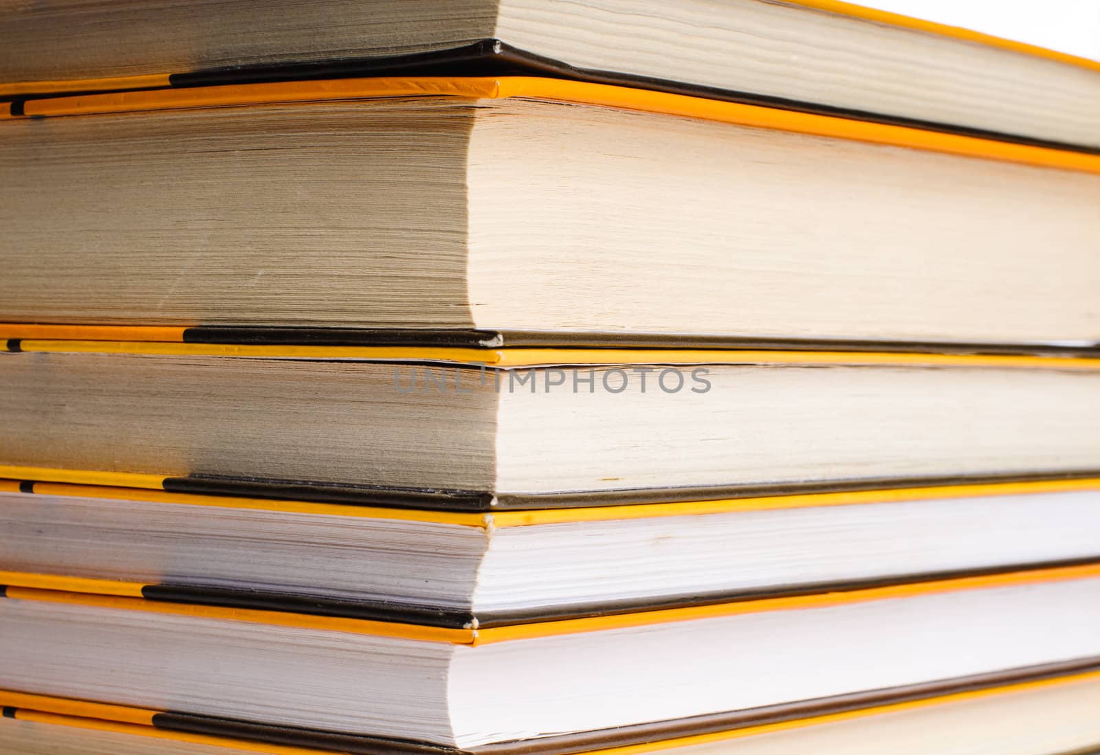 Big stack of yellow books isolated on white background