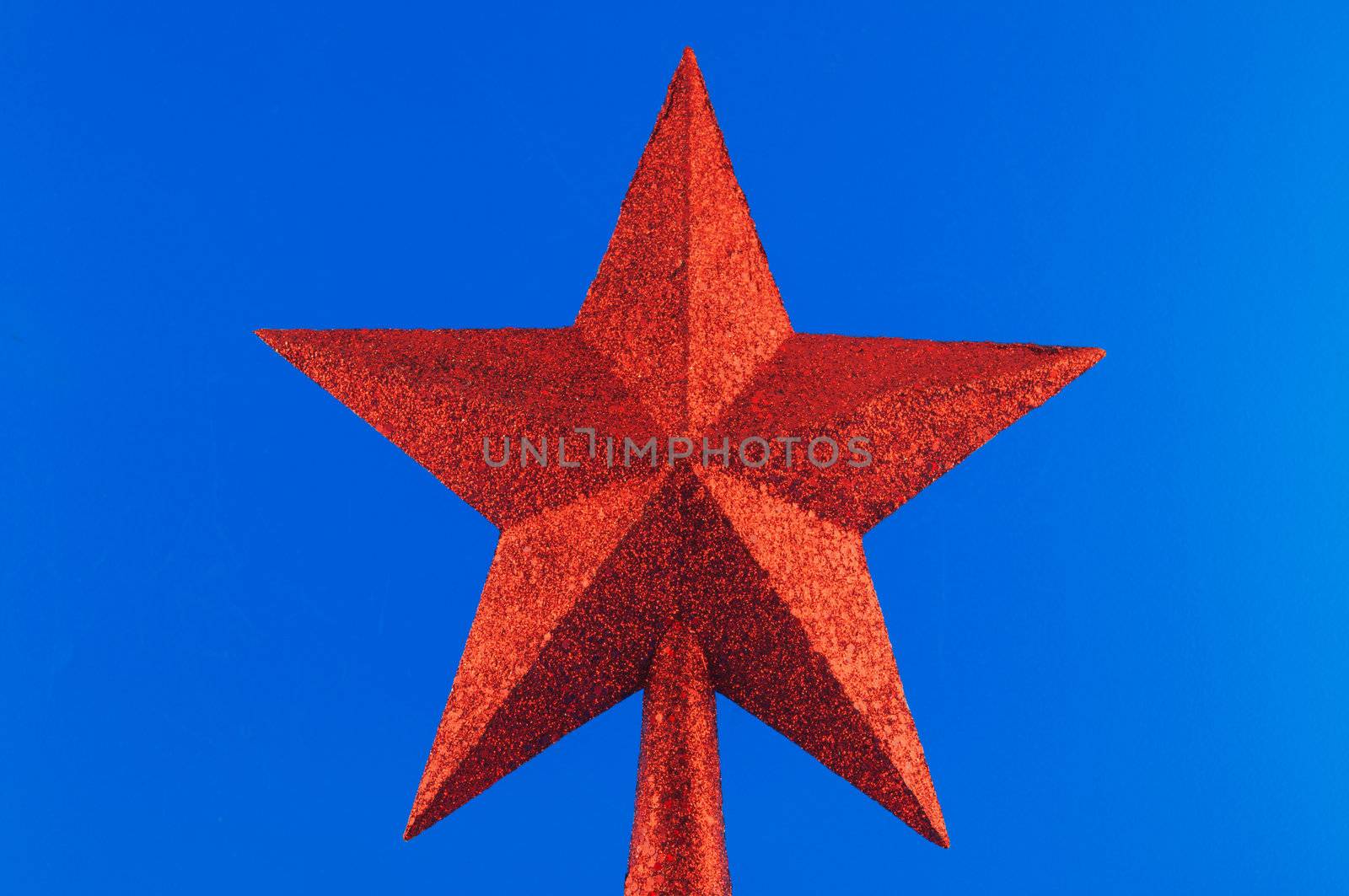  Red five-pointed star toy Christmas tree against a white background 