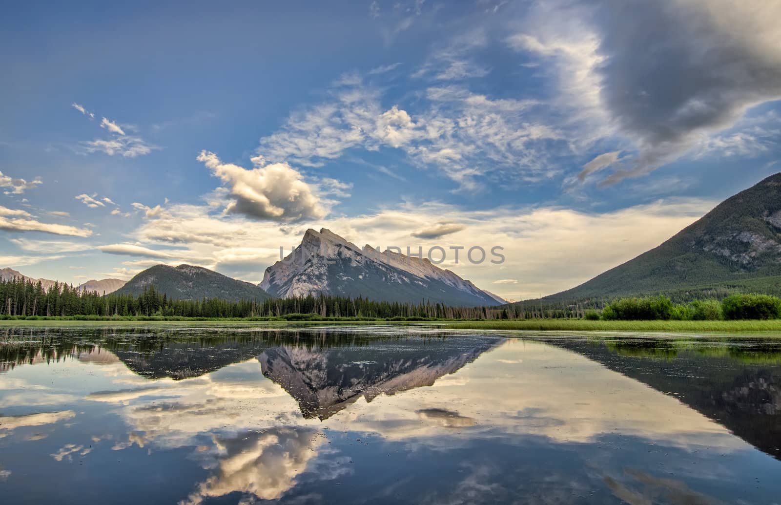 A perfect reflection of the rocky mountains in Vermilion lakes, in Banff National Park Canada.