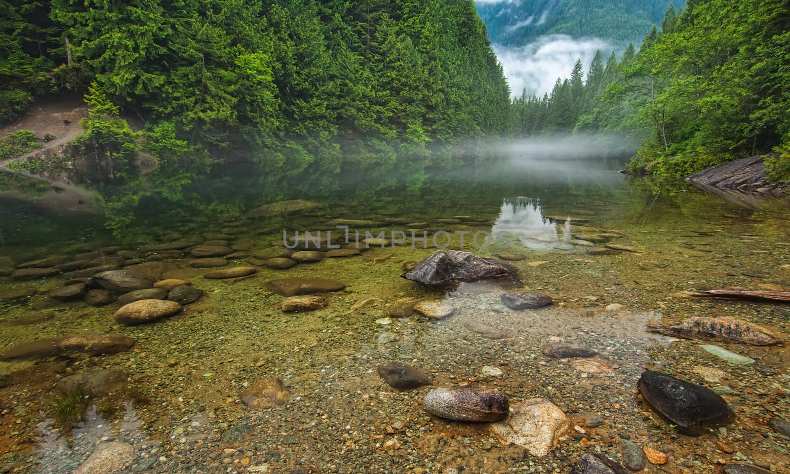 Clear Lake With Rocks and Mist in Distance by JamesWheeler