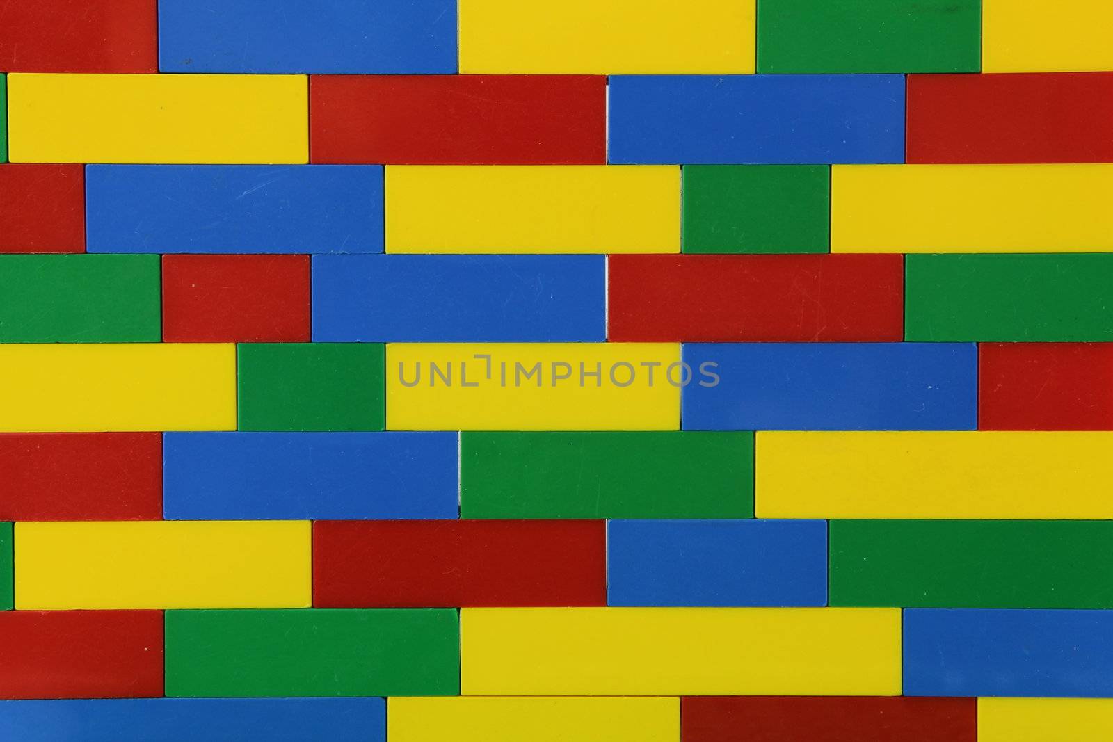 Multi coloured lego wall on white background