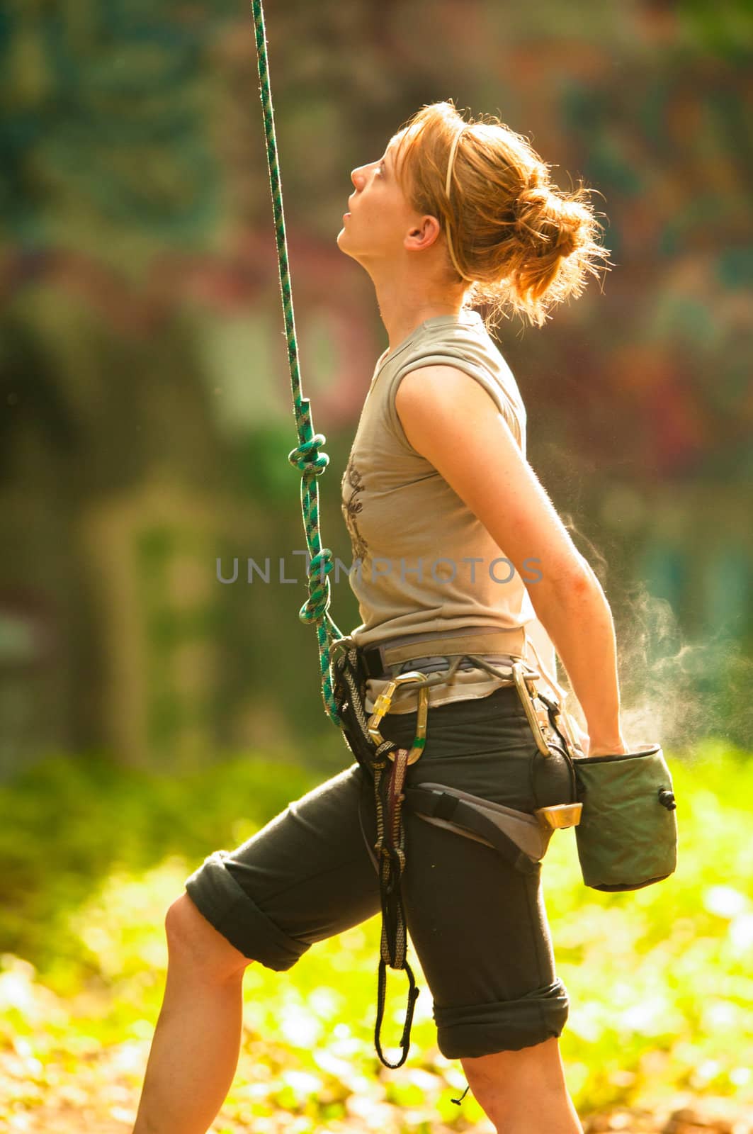 Female rock climber climbing a stone structure