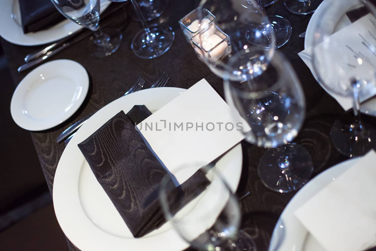 Blank card at restaurant dinner place setting