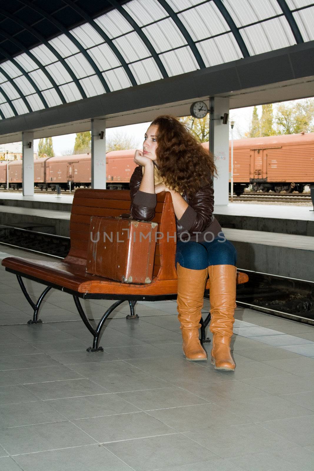 girl with vintage suitcase sits on the ramp