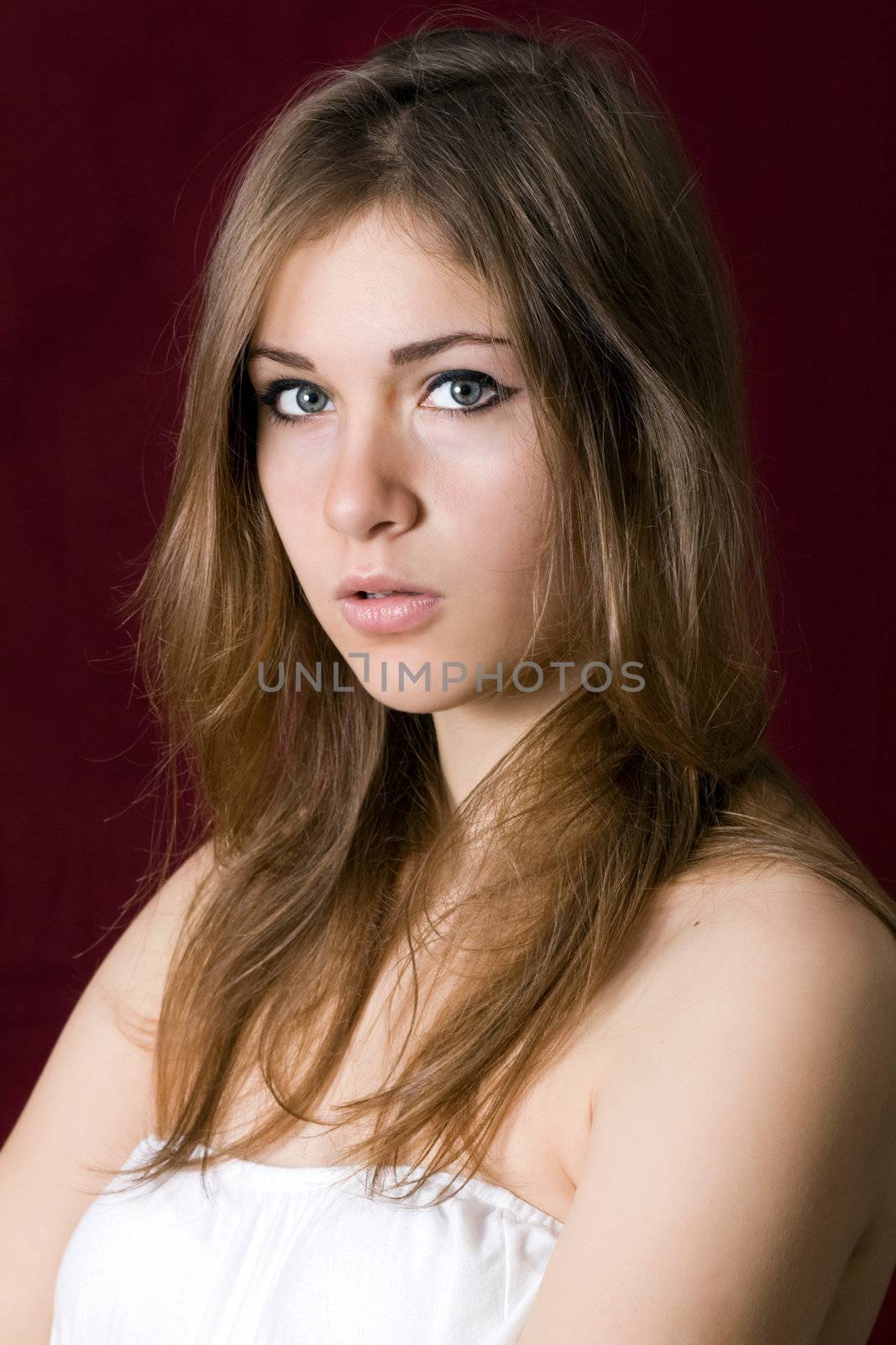 Portrait of beautiful fashion model on red background