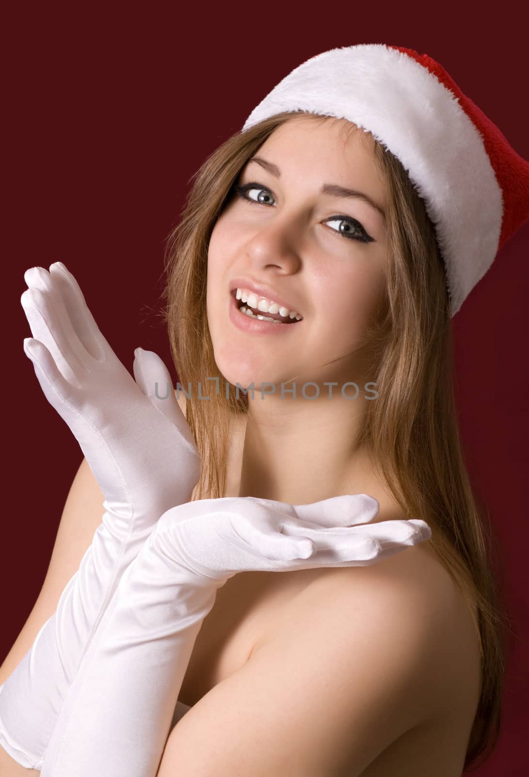 Young happy girl in Christmas hat.