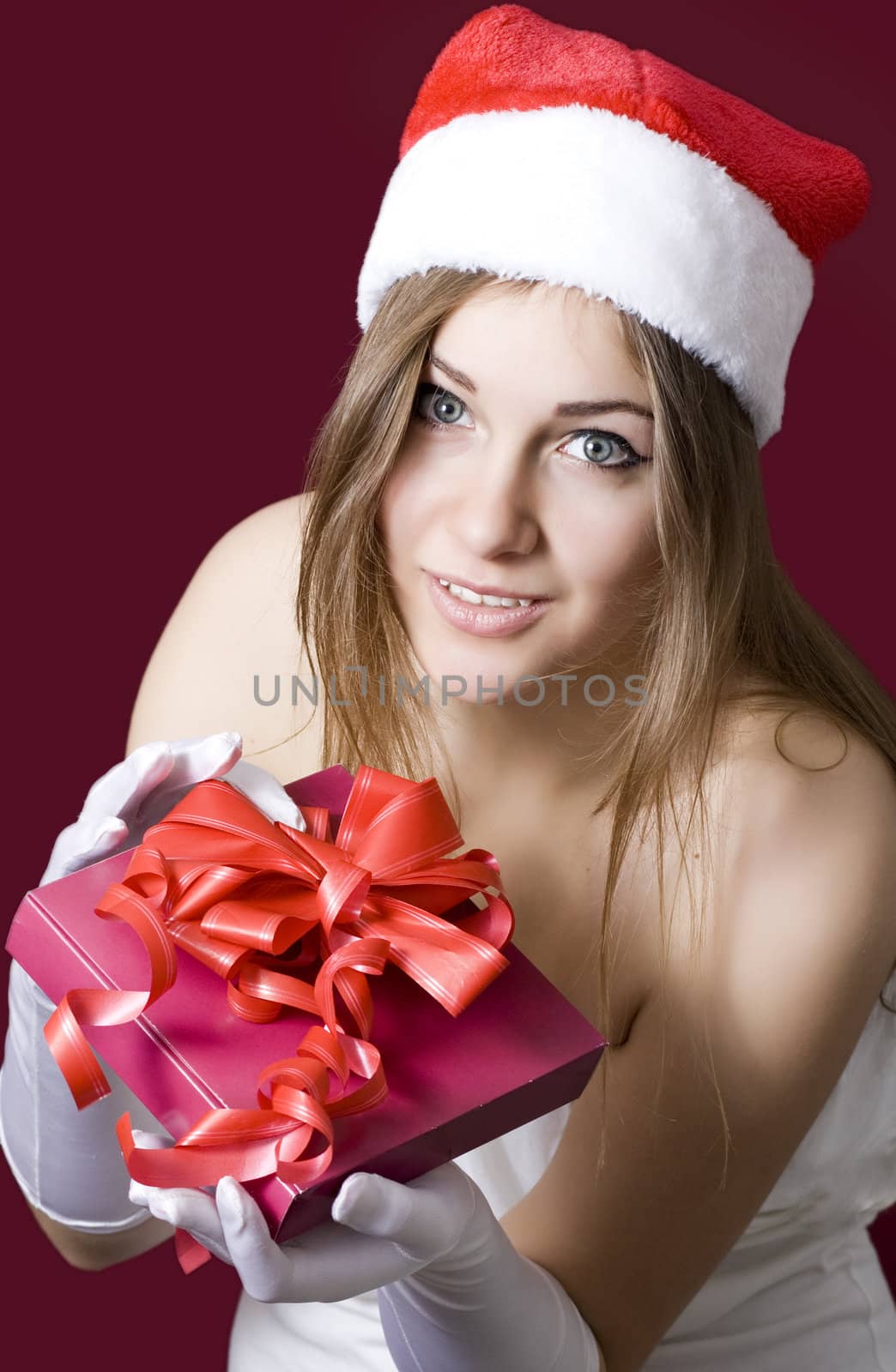 Standing indoors and holding christmas gift