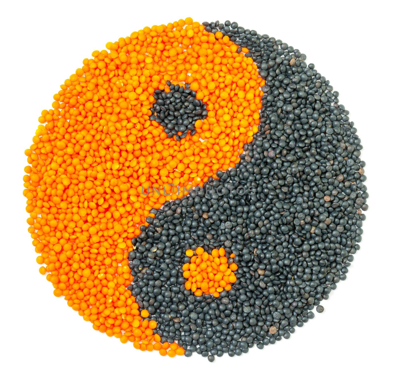 Orange and Black Lentil forming a yin yang symbol, isolated on white